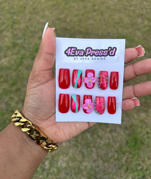 Hand holding a sheet of red and pink nail art designs with '4Eva Pressd' branding.