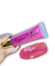 Load image into Gallery viewer, Secure The Bag with this Juicy Plum Tinted Gloss $ix Figures is Embellished with a Slight Gold Shimmer that Leave Your Lips with an Elite Shine.    Infused with Lip Plumper for a Naturally Full Look. Coconut Oil, Organic Jojoba Oil, &amp; Vitamin E for a Smooth Silky Finish.   ✨Non-Sticky ✨High Shine ✨ Perfect Tint  ✨Long Lasting ✨Vegan &amp; Cruelty Free 